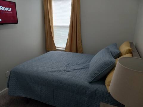 Bedroom with full bed and television